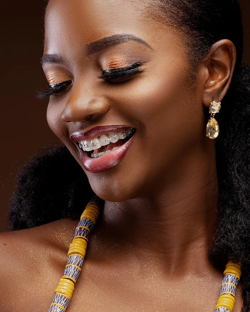 Woman with striking makeup and clear braces