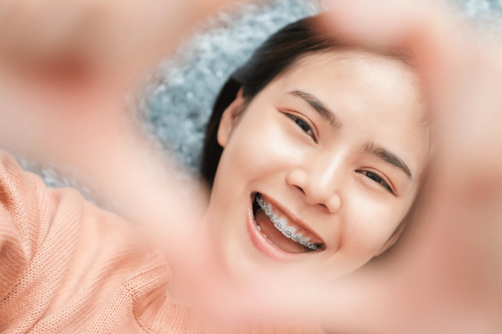 girl smiling with broken bracket braces