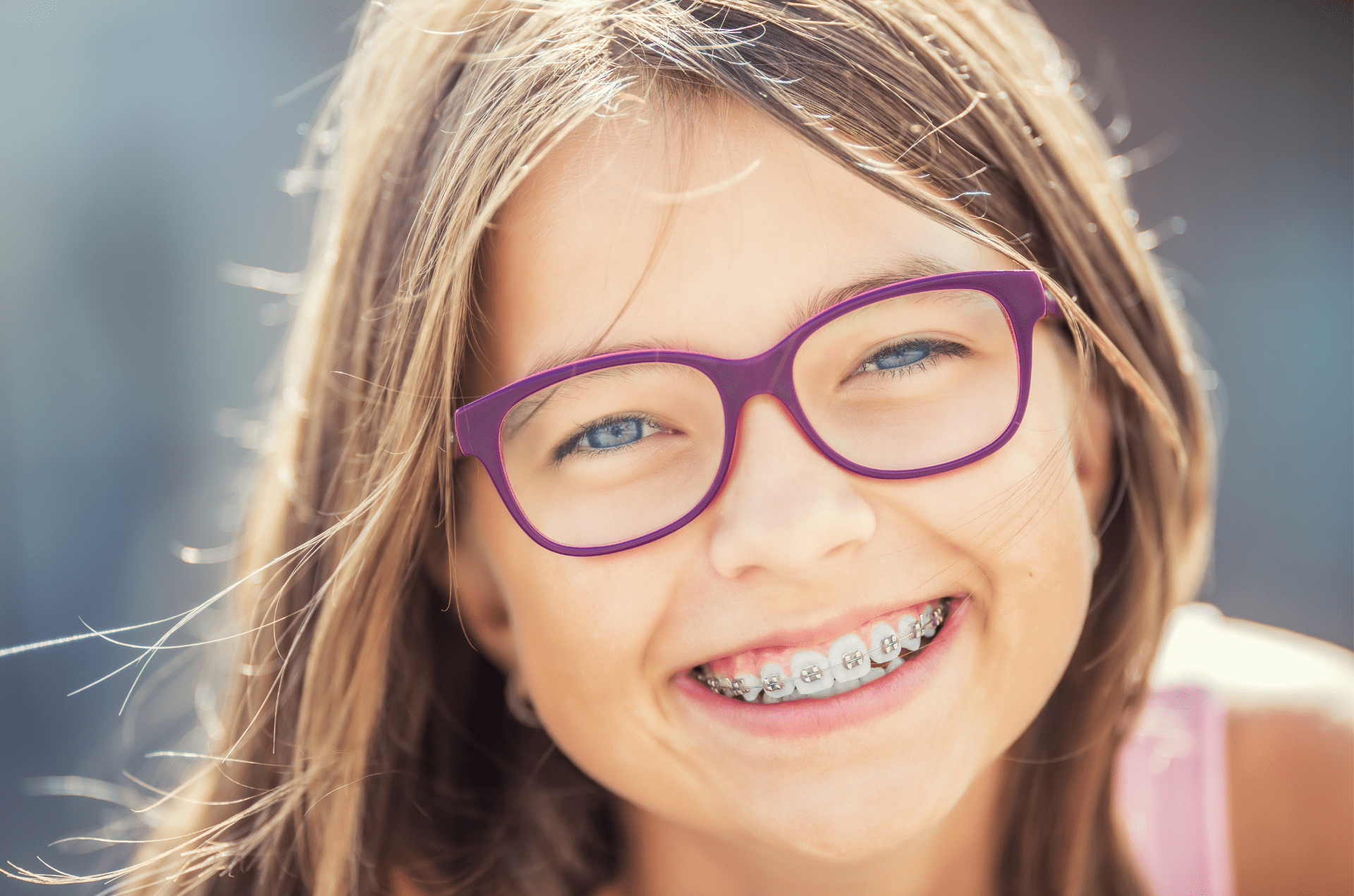 young girl with new braces smiling about starting orthodontic treatment