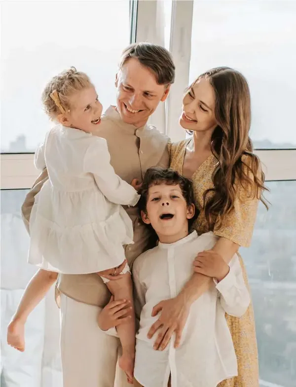 Family smiling after orthodontic treatment at Pura Vida Orthodontics in Spring Lake Park